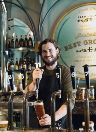 Bartender pouring a beer at the Endeavour Tap Rooms, The Rocks