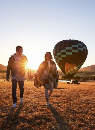 Couple arriving for a sunrise hot air balloon ride in the Hunter Valley