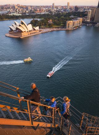 Friends enjoying a twilight BridgeClimb Sydney experience overlooking Sydney Harbour