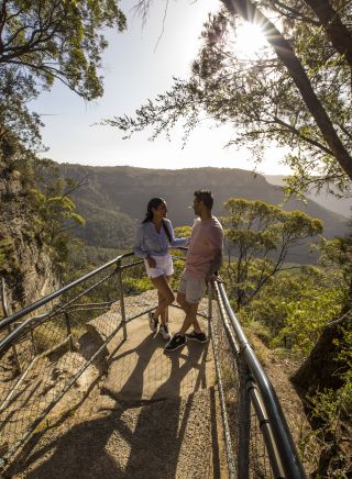 Couple enjoying views overlooking the Jamison Valley along the Giant Stairway Walking Track, Katoomba
