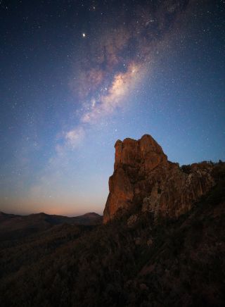 Stars lighting up the night sky over the Breadknife rock formation in Warrumbungle National Park