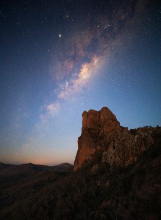 Stars lighting up the night sky over the Breadknife rock formation in Warrumbungle National Park