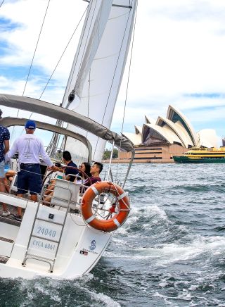 People enjoying a chartered sailing tour on Sydney Harbour