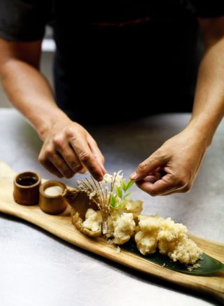 Chef preparing a dish at Toko Restaurant and Bar in Surry Hills