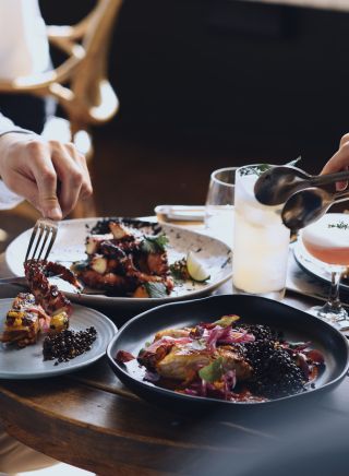 Couple enjoying food and drink at The Butler, an open patio bar located on Victoria Street, Potts Point