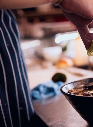 Chef making a bowl of ramen at the Rising Sun Workshop cafe in Newtown, Inner Sydney