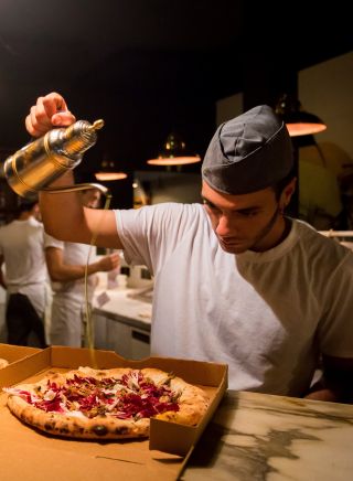 Chef preparing pizza's at Gigi Pizzeria, Newtown