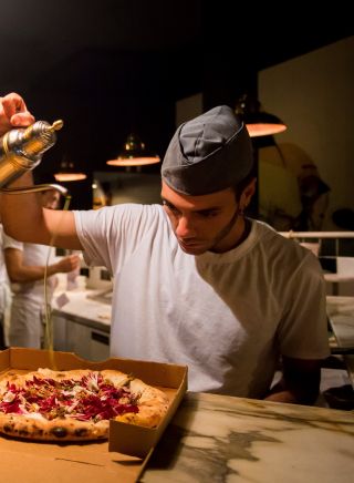 Chef preparing pizza's at Gigi Pizzeria, Newtown