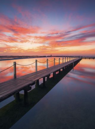 Sun rising over North Narrabeen Rockpool, Narrabeen