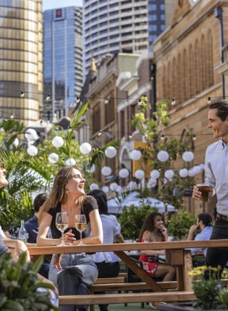 Couples enjoying the outdoor dining seating areas in The Rocks, Sydney