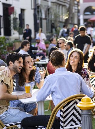 Friends enjoying drinks in the afternoon at the Orient Hotel in The Rocks, Sydney City