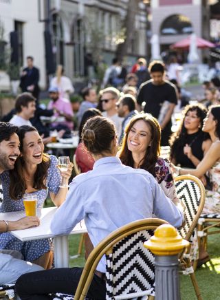 Friends enjoying drinks in the afternoon at the Orient Hotel in The Rocks, Sydney City