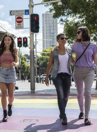 Couples crossing the rainbow path near Taylor Square, Darlinghurst