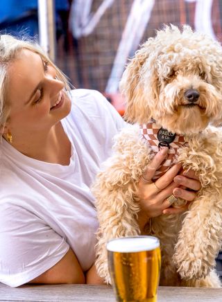 Woman with her dog in the courtyard at Vic on the Park, Enmore