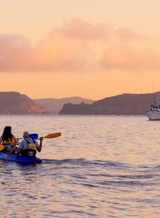 Friends enjoying a sunrise kayaking experience in Pittwater with Pittwater Kayak Tours, Palm Beach