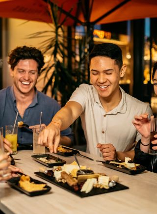 Friends enjoying food and drinks at Nick and Noras, Parramatta