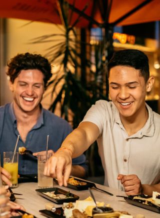 Friends enjoying food and drinks at Nick and Noras, Parramatta