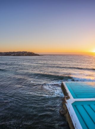Morning sun rising over Bondi Icebergs, Bondi Beach
