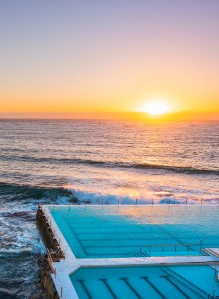 Morning sun rising over Bondi Icebergs, Bondi Beach