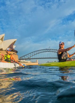 Kayakers enjoying Sydney harbour near the Sydney Opera House with the Sydney harbour bridge in the background, Sydney Harbour