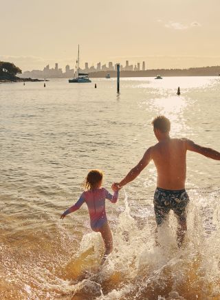 A father and child enjoying the water at Camp Cove, Watsons Bay