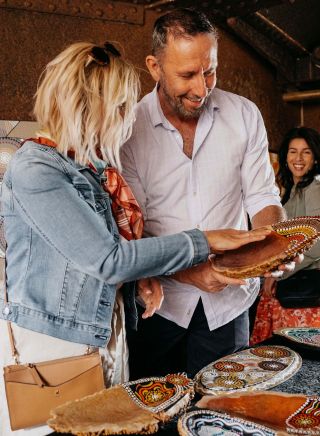 Couple browsing through Aboriginal artwork for sale, Blak Markets, Bare Island, La Perouse