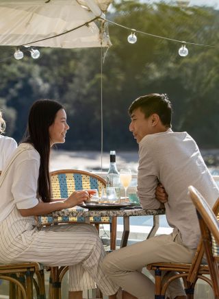 Couple enjoying food and drink with views of Balmoral Beach, Bathers Pavilion, Mosman