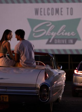 Couple sitting in their car ready to watch a movie at the Skyline Drive, Blacktown