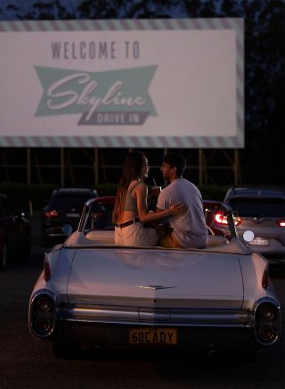 Couple sitting in their car ready to watch a movie at the Skyline Drive, Blacktown