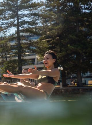 Friends having fun with yoga moves on a paddleboard with Flow mOcean, Manly