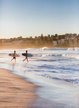 Surfers heading for a morning surf, Bondi Beach