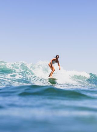 Surfer riding a wave off, Bilgola Beach