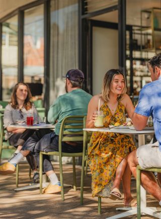 Friends drinking at outdoor cafe, Blackwood Cafe, Bondi 