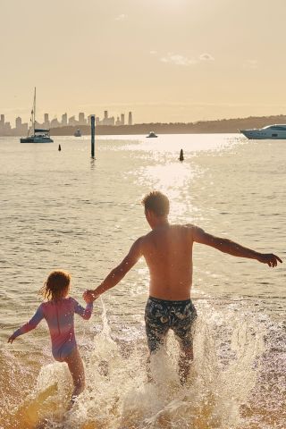 A father and child enjoying the water at Camp Cove, Watsons Bay