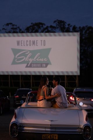 Couple sitting in their car ready to watch a movie at the Skyline Drive, Blacktown