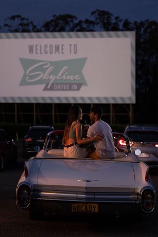 Couple sitting in their car ready to watch a movie at the Skyline Drive, Blacktown
