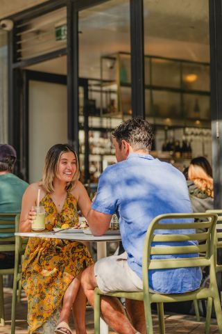 Friends drinking at outdoor cafe, Blackwood Cafe, Bondi 