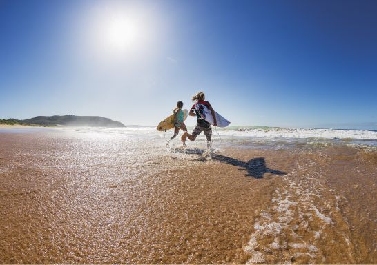 Two surfers heading out to enjoy the morning waves at Sydney's Palm Beach