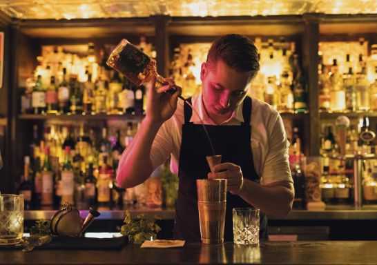 Bartender creating a cocktail at The Doss House bar in The Rocks, Sydney City 