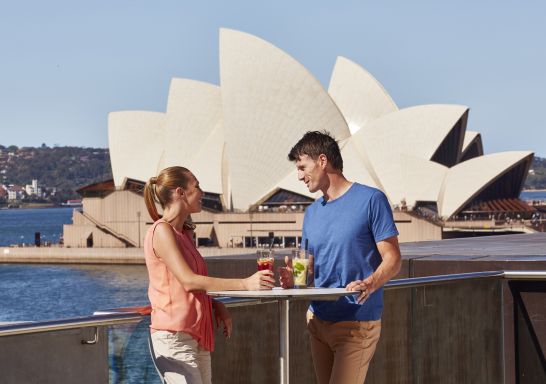 Couple enjoy the views at the Museum of Contemporary Art (MCA) Cafe in The Rocks, Sydney