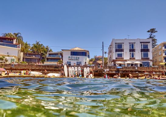 Views of beachgoers at Cabbage Tree Bay Aquatic Reserve, Manly from the water