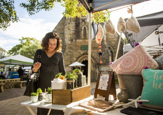 Woman browsing homewares at Balmain Markets in Balmain