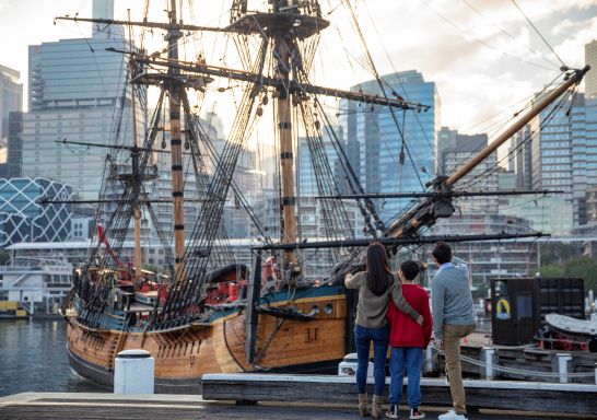Family exploring the HMB Endeavour, an Australian-built replica of James Cook's ship on exhibit at the Australian National Maritime Museum, Darling Harbour