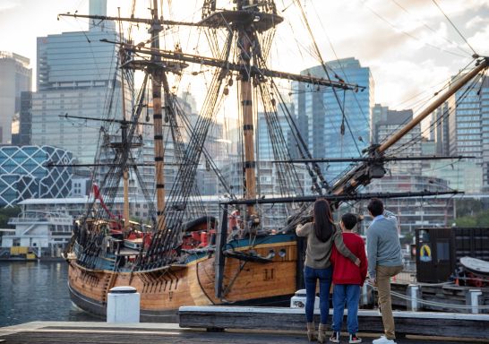 Family exploring the HMB Endeavour, an Australian-built replica of James Cook's ship on exhibit at the Australian National Maritime Museum, Darling Harbour