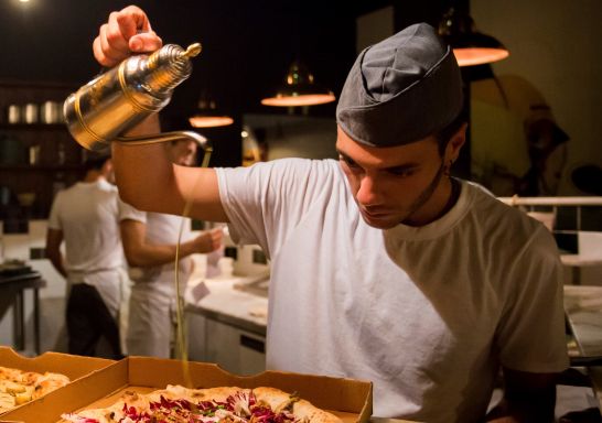 Chef preparing pizza's at Gigi Pizzeria, Newtown