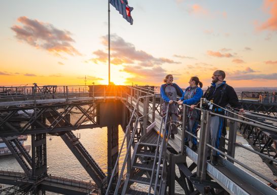 Friends enjoying a twilight BridgeClimb Sydney experience overlooking Sydney Harbour, Sydney