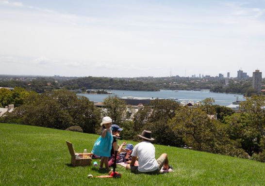 Family enjoying picnic and their food at Observatory Hill - The Rocks - Sydney City