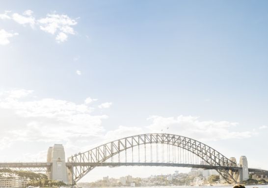 Couple enjoying food and drink with harbour views at Opera Bar, Sydney CBD