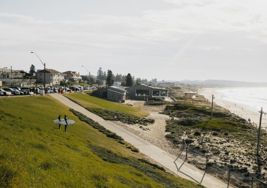 Surfers heading into the water at Wanda Beach, Cronulla