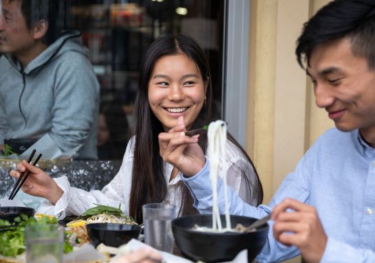 Couple enjoying food and drink at VN Street Foods, Marrickville 